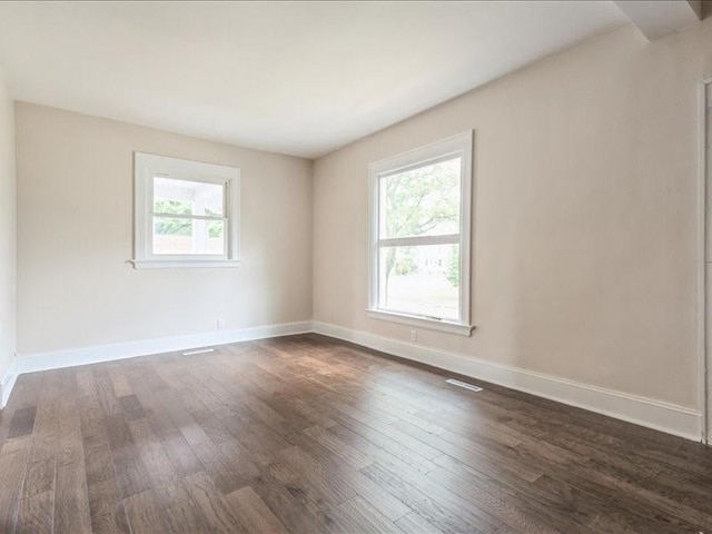 1308 A Ave NW, Cedar Rapids, IA 52405 - spare room featuring dark wood finished floors and baseboards