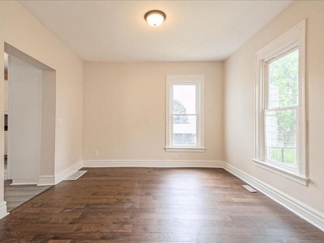 1308 A Ave NW, Cedar Rapids, IA 52405 - empty room featuring plenty of natural light and dark wood-style floors