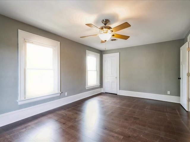1308 A Ave NW, Cedar Rapids, IA 52405 - empty room with a ceiling fan and dark wood-type flooring