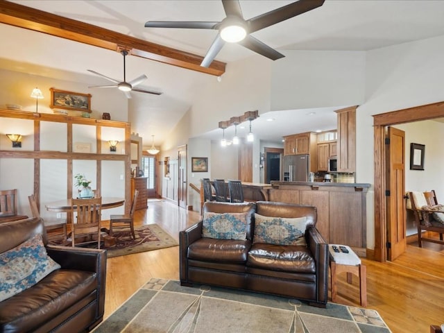 929 Willow Ln Unit A, Lisbon, IA 52253 - living room with a ceiling fan, light wood-style flooring, high vaulted ceiling, and beam ceiling