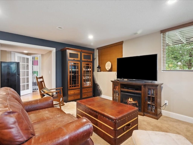 929 Willow Ln Unit A, Lisbon, IA 52253 - living area featuring recessed lighting, a warm lit fireplace, and light carpet