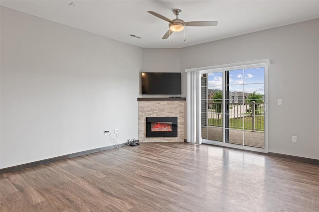 2871 Spring Rose Cir Unit 207, Coralville, IA 52241 - unfurnished living room with a fireplace, a ceiling fan, and wood finished floors