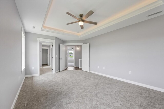 3911 Winnsboro Dr, Iowa City, IA 52245 - unfurnished bedroom featuring a raised ceiling, carpet flooring, and ceiling fan