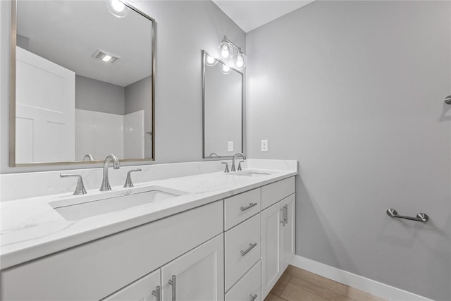 3911 Winnsboro Dr, Iowa City, IA 52245 - bathroom with double vanity and baseboards