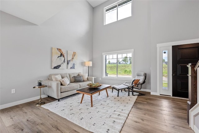 3911 Winnsboro Dr, Iowa City, IA 52245 - living room with high vaulted ceiling, plenty of natural light, and wood finished floors