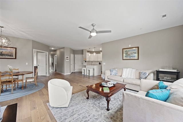 260 N Scott Blvd Unit 201, Iowa City, IA 52245 - living room featuring light wood finished floors and a ceiling fan