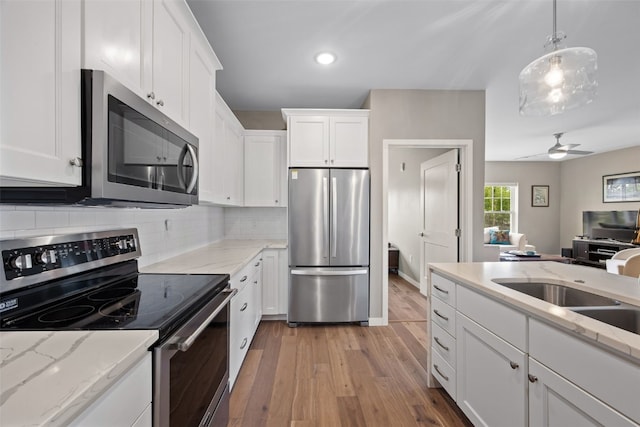 260 N Scott Blvd Unit 201, Iowa City, IA 52245 - kitchen with appliances with stainless steel finishes, light wood-style flooring, white cabinetry, backsplash, and recessed lighting