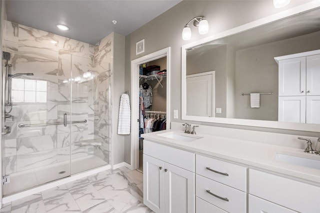 260 N Scott Blvd Unit 201, Iowa City, IA 52245 - full bathroom featuring marble look tile flooring, a marble finish shower, double vanity, a spacious closet, and recessed lighting