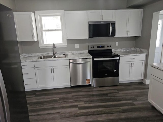920 E Washington St, Center Point, IA 52213 - kitchen with stainless steel appliances, white cabinetry, and dark wood-style flooring