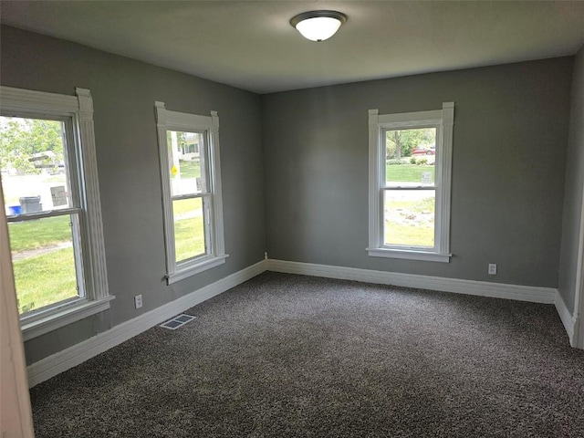 920 E Washington St, Center Point, IA 52213 - empty room with carpet and healthy amount of natural light