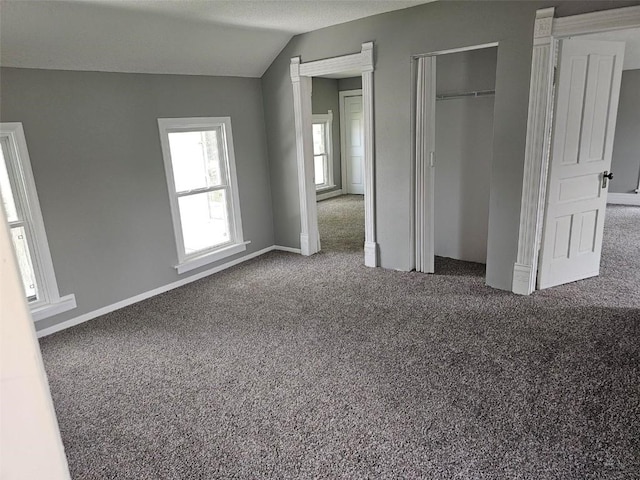 920 E Washington St, Center Point, IA 52213 - unfurnished bedroom featuring carpet floors, vaulted ceiling, and a closet