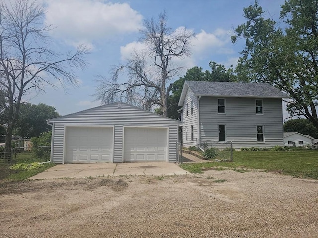 920 E Washington St, Center Point, IA 52213 - view of property exterior with a detached garage and an outbuilding