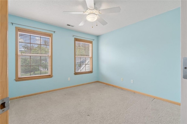 218 Teakwood Ln NE, Cedar Rapids, IA 52402 - spare room featuring carpet flooring and a textured ceiling