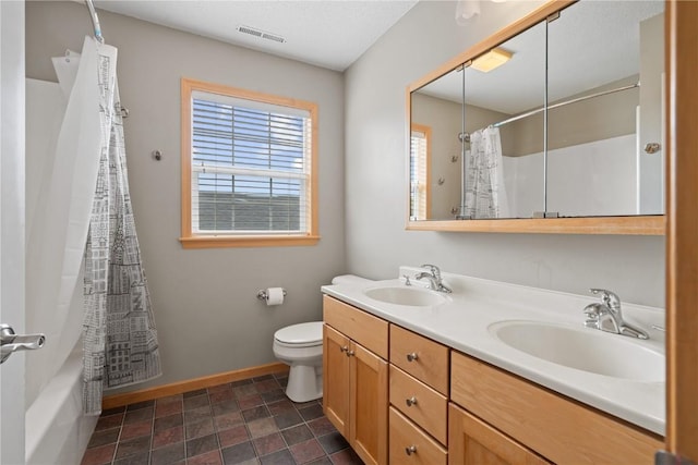 218 Teakwood Ln NE, Cedar Rapids, IA 52402 - bathroom with double vanity, stone finish flooring, and shower / tub combo