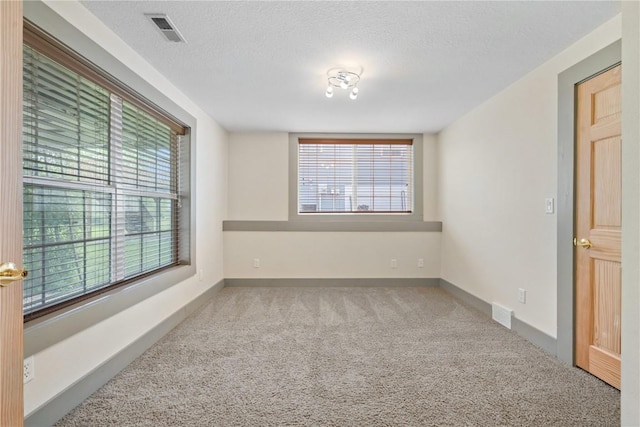 218 Teakwood Ln NE, Cedar Rapids, IA 52402 - carpeted spare room featuring a textured ceiling