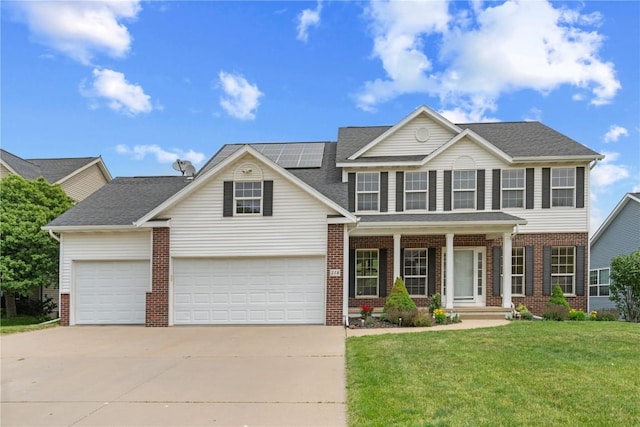 218 Teakwood Ln NE, Cedar Rapids, IA 52402 - view of front of home featuring brick siding, concrete driveway, a front lawn, solar panels, and covered porch