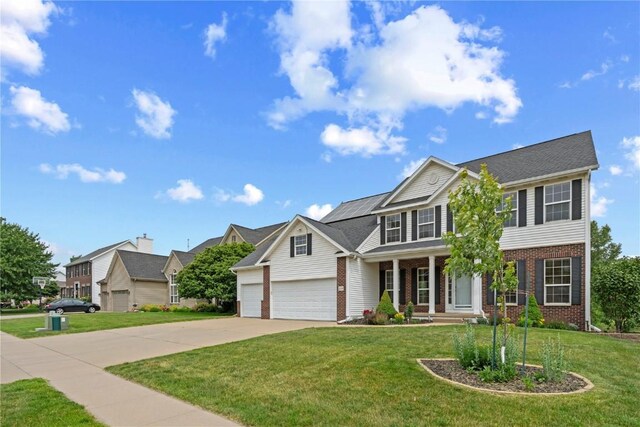 218 Teakwood Ln NE, Cedar Rapids, IA 52402 - view of front facade with brick siding, covered porch, driveway, a front lawn, and a garage