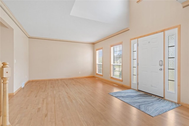 218 Teakwood Ln NE, Cedar Rapids, IA 52402 - foyer entrance featuring light wood finished floors and ornamental molding