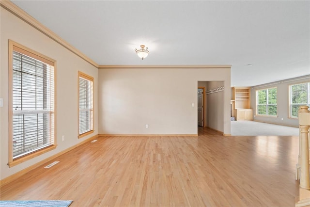 218 Teakwood Ln NE, Cedar Rapids, IA 52402 - unfurnished room featuring wood finished floors, ornamental molding, and built in shelves
