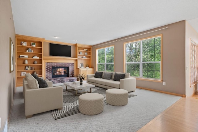218 Teakwood Ln NE, Cedar Rapids, IA 52402 - living room with wood finished floors, a fireplace, and built in features