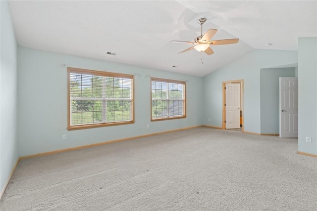 218 Teakwood Ln NE, Cedar Rapids, IA 52402 - empty room featuring light colored carpet, a ceiling fan, plenty of natural light, and vaulted ceiling