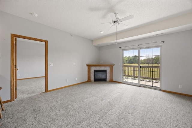250 Cimarron Dr NE, Hiawatha, IA 52233 - unfurnished living room featuring carpet flooring, ceiling fan, a tile fireplace, and a textured ceiling