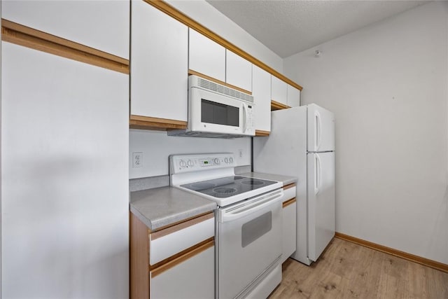 250 Cimarron Dr NE, Hiawatha, IA 52233 - kitchen featuring white appliances, light wood-type flooring, white cabinetry, and light countertops