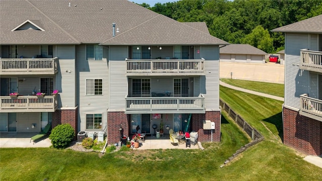 250 Cimarron Dr NE, Hiawatha, IA 52233 - back of house featuring a patio area, a balcony, brick siding, and a lawn