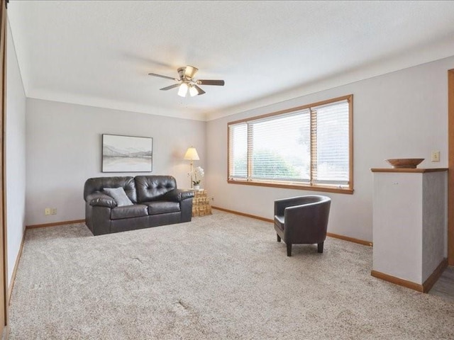 8 25th Ave SW, Cedar Rapids, IA 52404 - carpeted living room featuring a ceiling fan and crown molding