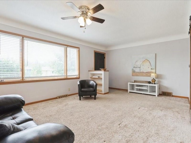8 25th Ave SW, Cedar Rapids, IA 52404 - carpeted living room featuring ceiling fan and baseboards