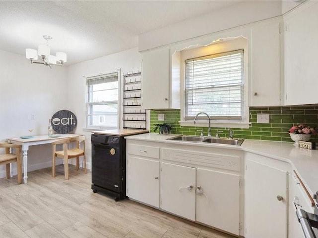 8 25th Ave SW, Cedar Rapids, IA 52404 - kitchen featuring light countertops, backsplash, a chandelier, and white cabinets
