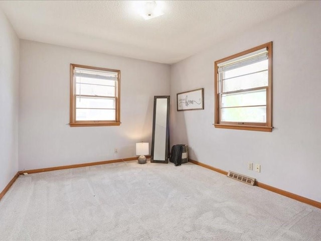 8 25th Ave SW, Cedar Rapids, IA 52404 - carpeted empty room featuring healthy amount of natural light