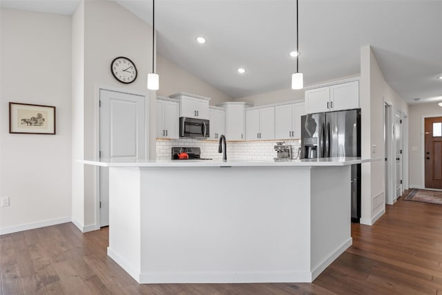 4263 Calder Dr, Marion, IA 52302 - kitchen with stainless steel appliances, white cabinets, tasteful backsplash, light countertops, and vaulted ceiling