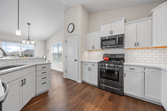 4263 Calder Dr, Marion, IA 52302 - kitchen featuring stainless steel appliances, lofted ceiling, decorative backsplash, light countertops, and white cabinetry