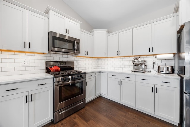 4263 Calder Dr, Marion, IA 52302 - kitchen featuring appliances with stainless steel finishes, light countertops, white cabinets, dark wood-style floors, and backsplash
