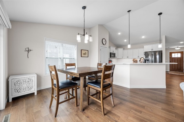 4263 Calder Dr, Marion, IA 52302 - dining space with recessed lighting, wood finished floors, and vaulted ceiling