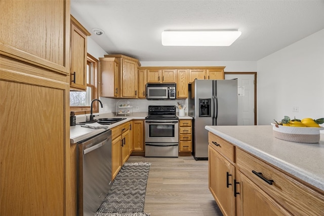 13294 212th Ave, Anamosa, IA 52205 - kitchen featuring appliances with stainless steel finishes, light countertops, and light wood finished floors