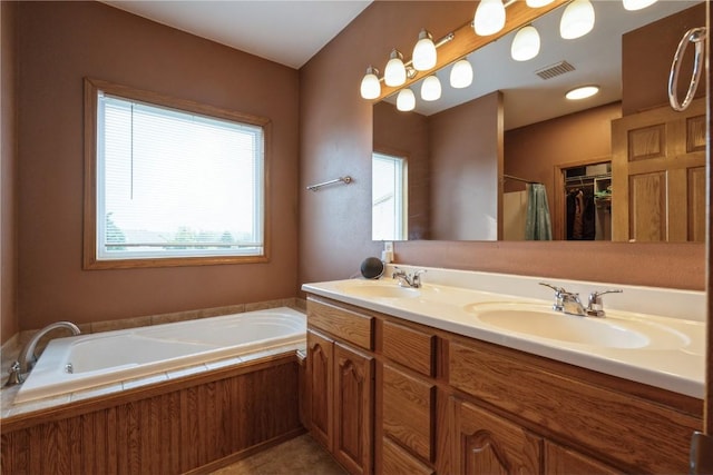 765 34th Ave, Marion, IA 52302 - bathroom featuring healthy amount of natural light, double vanity, and a bath