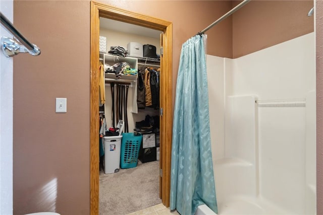 765 34th Ave, Marion, IA 52302 - full bathroom featuring curtained shower and a spacious closet