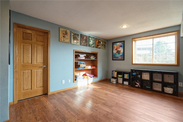 765 34th Ave, Marion, IA 52302 - rec room with wood finished floors and built in shelves