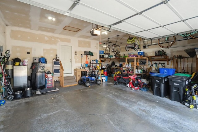 765 34th Ave, Marion, IA 52302 - garage with a garage door opener and a workshop area
