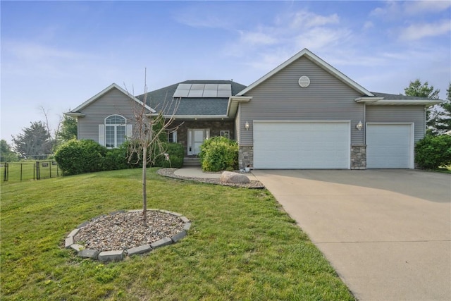 765 34th Ave, Marion, IA 52302 - view of front of house featuring an attached garage, solar panels, concrete driveway, roof with shingles, and stone siding