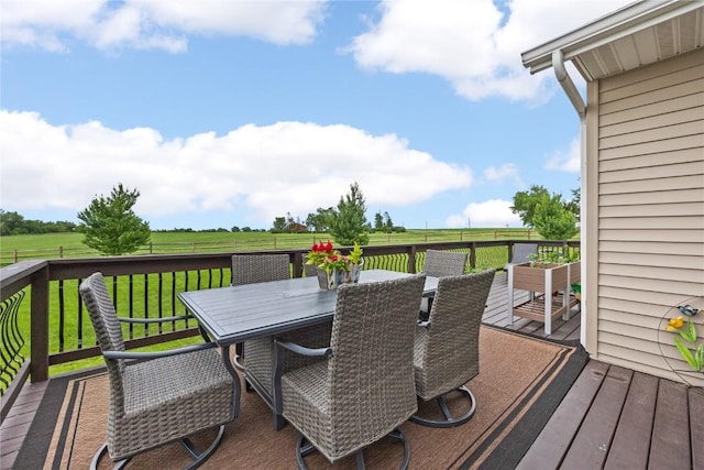 635 Deer Ridge Dr, Atkins, IA 52206 - deck featuring outdoor dining area, a lawn, and a rural view