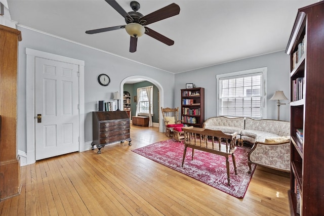 1812 Blake Blvd SE, Cedar Rapids, IA 52403 - living area with a ceiling fan, arched walkways, wood-type flooring, and crown molding