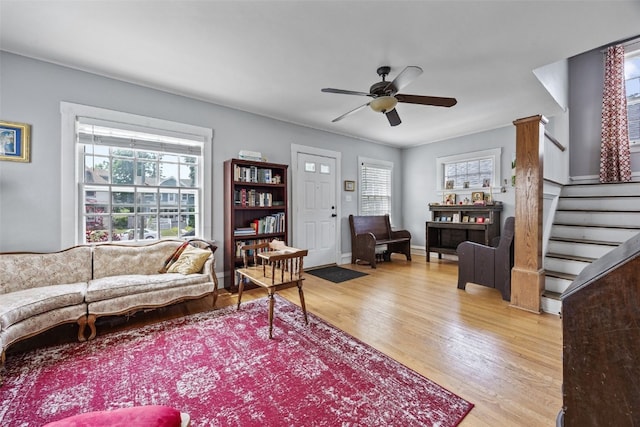 1812 Blake Blvd SE, Cedar Rapids, IA 52403 - living room with light wood-type flooring, a ceiling fan, and stairs