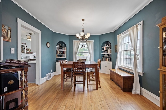 1812 Blake Blvd SE, Cedar Rapids, IA 52403 - dining area with a chandelier, light wood finished floors, crown molding, built in features, and ceiling fan