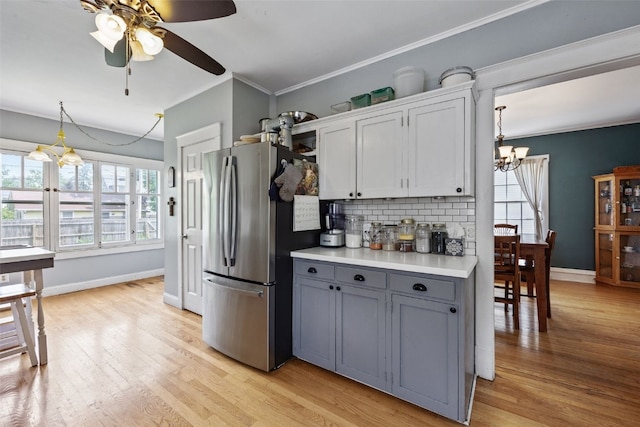 1812 Blake Blvd SE, Cedar Rapids, IA 52403 - kitchen featuring freestanding refrigerator, a chandelier, tasteful backsplash, gray cabinets, and light countertops