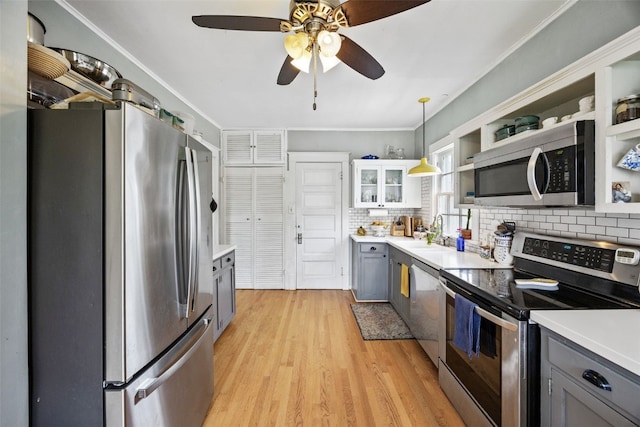 1812 Blake Blvd SE, Cedar Rapids, IA 52403 - kitchen featuring appliances with stainless steel finishes, gray cabinetry, decorative backsplash, light wood-type flooring, and light countertops