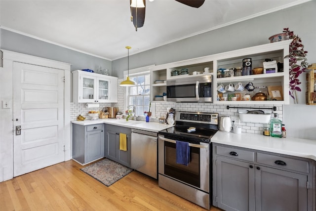 1812 Blake Blvd SE, Cedar Rapids, IA 52403 - kitchen featuring stainless steel appliances, gray cabinets, open shelves, decorative backsplash, and crown molding