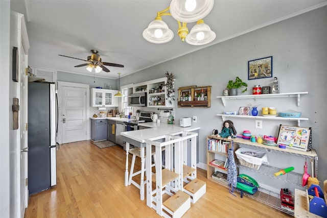 1812 Blake Blvd SE, Cedar Rapids, IA 52403 - kitchen with appliances with stainless steel finishes, open shelves, a ceiling fan, light wood finished floors, and light countertops